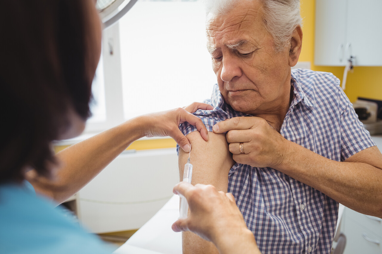 Female doctor giving an injection to a patient